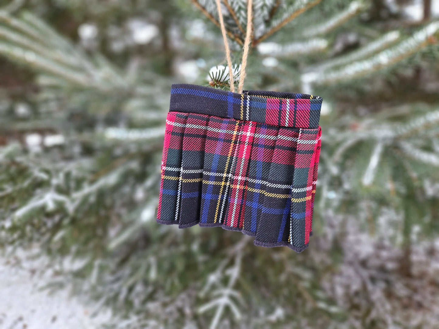 black stewart tartan mini kilt hanging on a tree branch